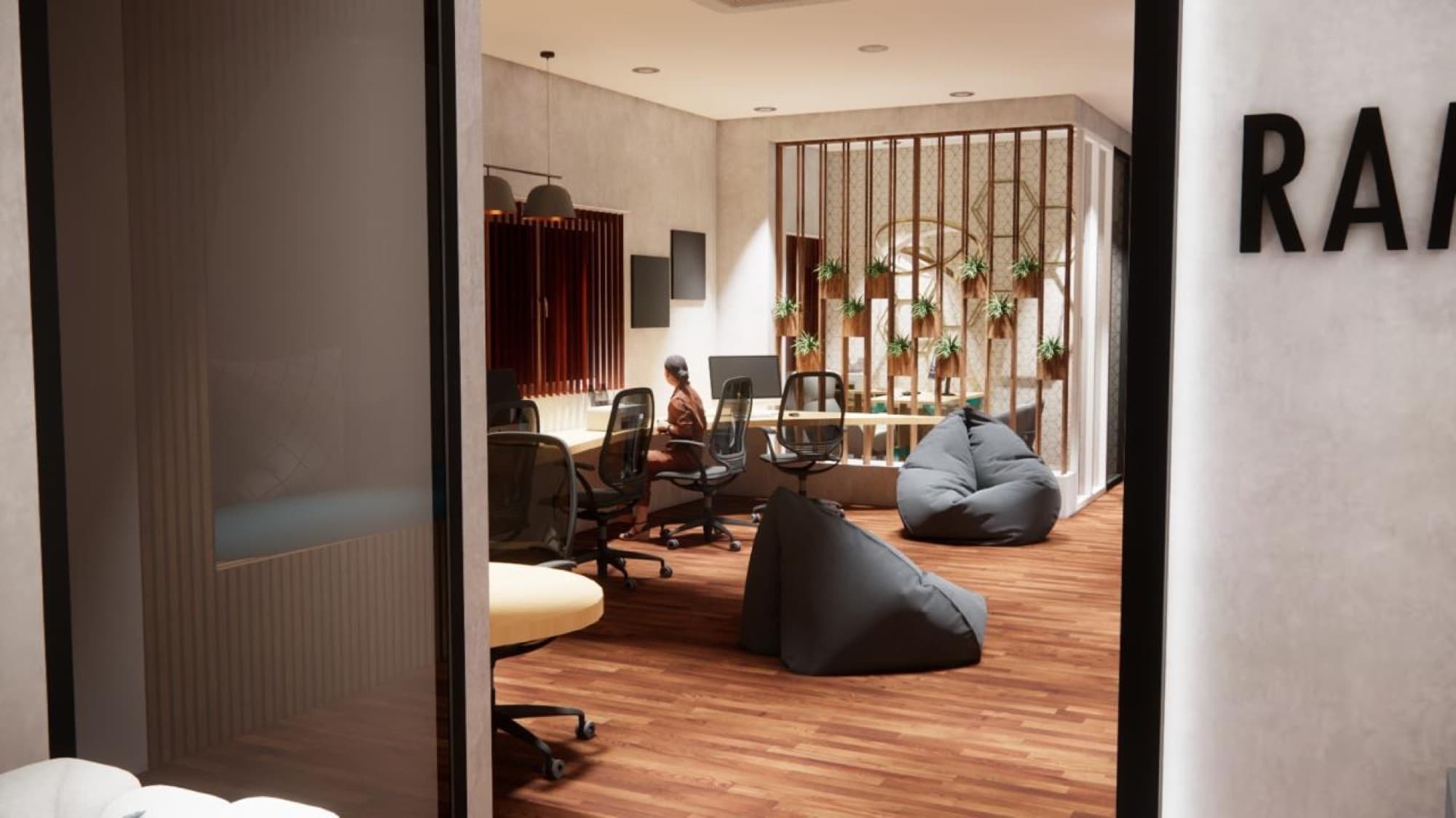 Breakout corner of the studio workspace design with soft seating and layered lighting